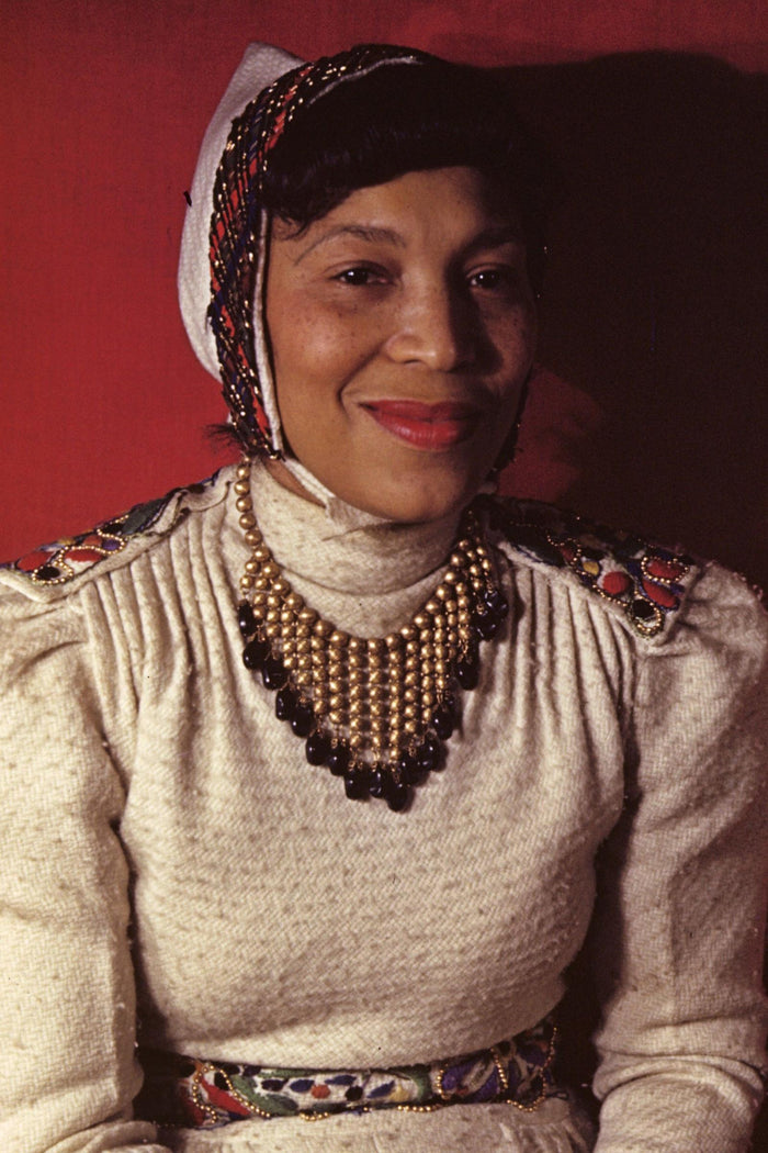 Portrait of Zora Neale Hurston in a headwrap and beaded necklace